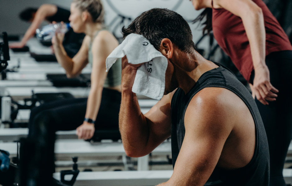 Member wiping his face with a STRONG towel in class